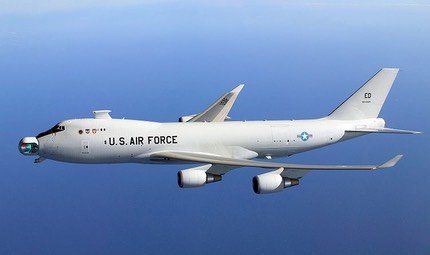 Boeing YAL-1 Airborne Laser in flight over water, showing its nose laser turret