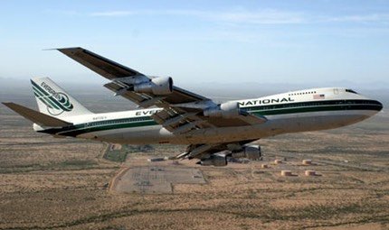 Evergreen Boeing 747 Supertanker in flight over desert terrain