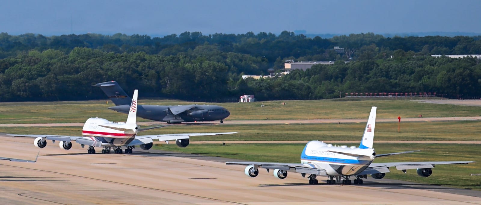 The VC-25B Bridge in its new red, white and blue livery taxiing at Joint Base Andrews alongside a VC-25A in the classic light blue presidential scheme